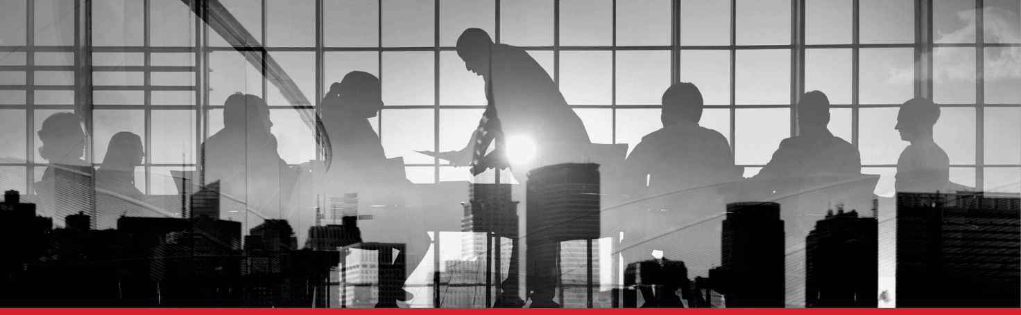 A boardroom in silhouette, one figure standing over the table while the rest wait
