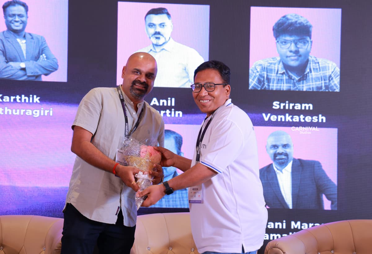 Maran being handed a bouquet on stage after a session
