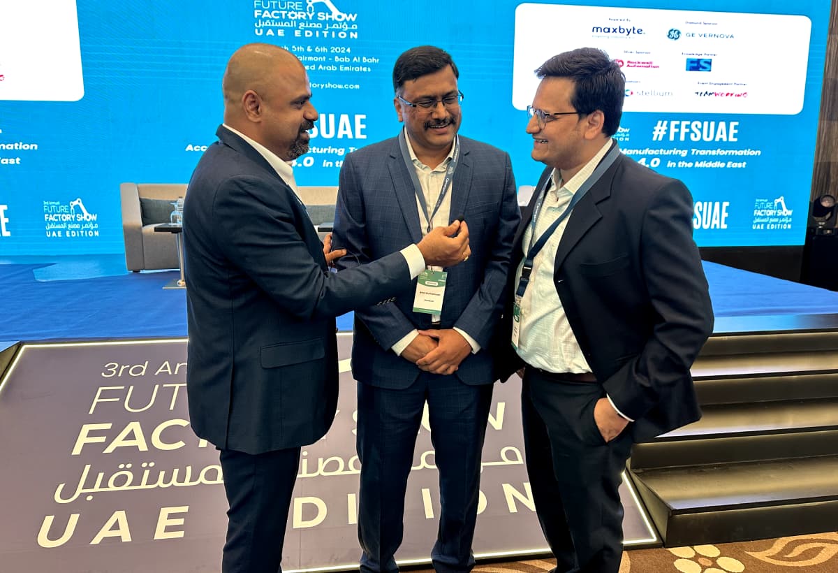 Maran in conversation with two delegates at the Future Factory Show in the UAE