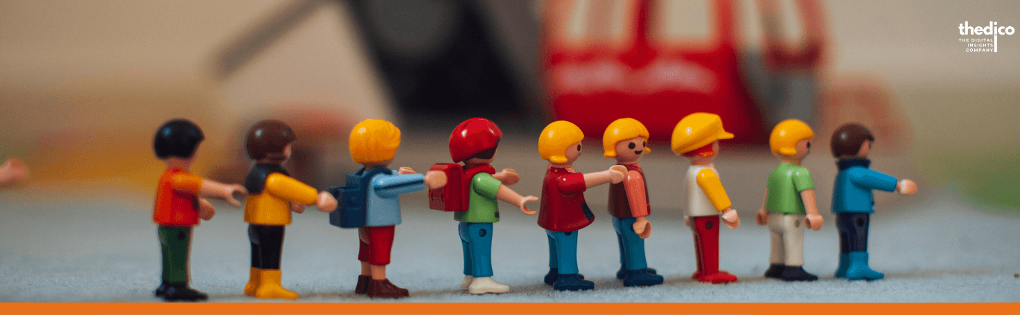 A line of toy figures passing a parcel from one to the next